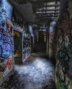 an abandoned building with graffiti all over the walls