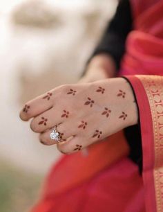 a close up of a person's hand with hendi tattoos on their fingers