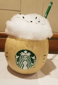 a starbucks drink in a foamy cup with a straw sticking out of the top