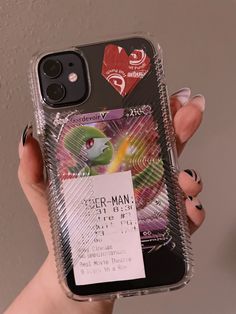 a person holding up a cell phone case with a concert ticket attached to the back