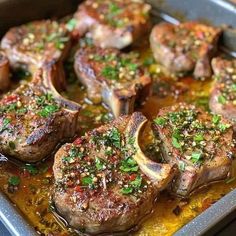 some steaks are cooking in a pan with sauce and seasoning on them,