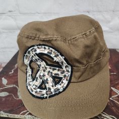 Look Stylish And Trendy With This M&F Women's Military Hat. This Hat Comes In A Beautiful Brown Color And Features A Cheetah Print Peace Sign Patch With Rhinestone Embellishments. It Is Made Of 100% Cotton, Which Makes It Comfortable To Wear During The Winter, Summer, Fall, And Spring Seasons. The Hat Is Perfect For Women And Can Be Worn On Various Occasions, Including Activewear, Casual And Workwear. It Is One Size Fits All, And You Can Adjust It To Your Liking. The Hat Is Not Only Fashionable Brown Military Hat, One Size Fits Most, Casual Brown Hat For Festival, Brown Casual Festival Hat, Casual Brown Festival Hat, Pink Bucket Hat, Vintage Hat Boxes, Knit Slouchy Hats, Girl Baseball Cap, Pink Baseball Cap