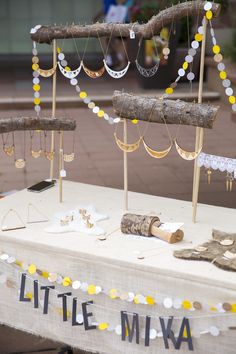 there is a table that has some kind of decoration on it with beads and wood sticks