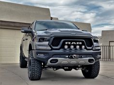 a ram truck parked in front of a garage