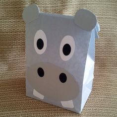 a paper bag with a hippo face on it's side and eyes open