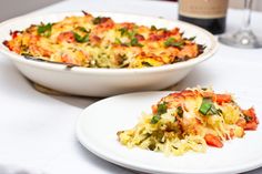 a white plate topped with food next to a casserole dish