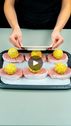 a person is preparing food on a tray