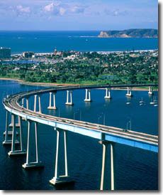 an aerial view of a bridge spanning the ocean