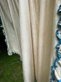 the curtains are pulled up and ready to be hung in the yard or patio area