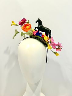 "Horse Fascinator- Day at the Races- Racing Headpiece - Mad Hatter- Kentucky Derby- Racing Fashion Hi,    This piece has a beautiful collection of flowers on a faux green moss is about 4\" wide. The black plastic horse is about 3\" high and 4\" long .  It's placed on the top of a skinny  1/4 \" satin covered headband that fits any adult head size.    -------------------------------------- If you like this try bigger version:  https://doramarra.etsy.com/listing/514762174 ------------------------- Spring Racing Headpieces With Pinched Crown, Spring Races Headpieces With Pinched Crown, Spring Races Headpiece With Pinched Crown, Multicolor Mini Hat Headband For Spring, Spring Races Headpiece With Structured Crown, Spring Multicolor Headpieces For Garden Party, Multicolor Headpieces For Spring Garden Party, Spring Garden Party Multicolor Headpieces, Handmade Flower Mini Hats For Spring Races