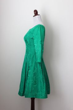 "Vintage 1950s green emerald cocktail dress with floral motif, 3/4 sleeves, pleated skirt and metal back zipper. Very well constructed dress. Size xs-s Bust 33\" Sleeves 17\" Waist 26\" Hips free Length 37\" Condition very good (some sign of wear by the front skirt and inside lining please see picture #5). <>Thank you for your visit<> www.etsy.com/shop/cocoandorange" Formal Green Dress With 3/4 Sleeves, Retro Green Evening Dress, Green Retro Evening Dress, Green Fitted Dress With 3/4 Sleeves, Green Evening Dress With Back Zipper, Green Retro Cocktail Dress, Green 3/4 Sleeve Party Dress, Green 3/4 Sleeve Dress For Party, Formal Green Fit And Flare Dress