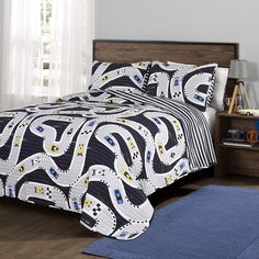 a bed with blue and white comforters in a bedroom