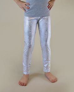 Glitzy, shimmery, metallic pants, while lightweight fabric little ones comfy. These glam metallic pants are fun, and fashionable and your little lady will love wearing them with their perfect amount of pizazz and shine.  100% polyester  We recommend hand washing and hang drying this article of clothing to keep the metallic shine from fading * 3 year - 21" waist / 23 1/2" length * 4 year - 21 1/2" waist / 25" length * 5 year - 22 1/2" waist / 26 1/2" length * 6 year - 24" waist / 27 1/2" length * Dress Up Leggings, Snake Leggings, Silver Leggings, Sequin Mask, Rainbow Leggings, Belle Costume, Sequin Leggings, Twirly Dress, Toddler Pants