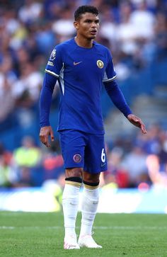 a soccer player is standing on the field