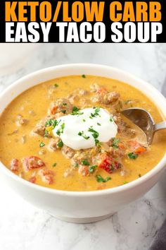 a close up of a bowl of soup with a spoon in it and the words keto / low carb easy taco soup