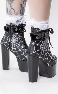 Super tall, super sexy, super spidery. The ultimate goth platform! The TORMENT-51 boots feature spiderweb embroidery on a matte black upper, contrasting with the patent black platform, heel and ankle strap. Crowning deets like the coffin buckle and spider charm are just *chef's kiss* Vegan Black PU leather 5 1/2 inch heel 3 inch platform Spiderweb Pattern Coffin Buckle Strap Lace up Side zip U.S women's sizing-refer to size chart for more info Spiderweb Embroidery, Shoes Platform Boots, Goth Platforms, Demonia Boots, Alternative Shoes, Gothic Boots, Goth Shoes, Demonia Shoes, Goth Boots