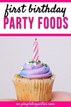 a hand holding a cupcake with a lit candle on it and the words first birthday party foods