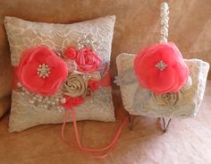 two pillows with flowers and pearls on them sitting on a couch next to each other