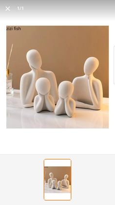 a group of white figurines sitting next to each other on top of a table