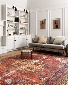 a living room filled with furniture and lots of bookshelves on top of it