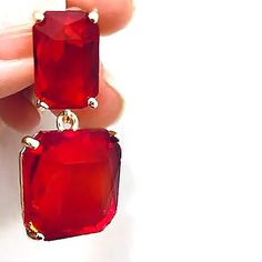 "Square Transparent Red Dangle Earrings that have a definite 60s-70s retro vibe. Earrings  are prong set  on a 18K gold plated setting.  The semi transparent multi faceted stones give off enough sparkle and shine  to make them perfect day or night.  Extra special  to wear on Easter Sunday  or to give  as a special gift to someone you  really care about!  Measurement:    1 1/2\" including the post  Material:              18K gold plated setting, crystal square and rectangular faceted stone Post:                     Stainless Steel, hypoallergenic, lead and nickel free  FREE SHIPPING on all items shipped in US .  All are packaged in gift boxes to insure  damage free arrival" Affordable Red Dangle Chandelier Earrings, Affordable Casual Red Earrings, Chic Red Earrings At Affordable Prices, Affordable Red Casual Earrings, Affordable Red Retro Earrings, Affordable Modern Red Earrings, Cheap Chic Red Earrings, Cheap Red Retro Jewelry, Affordable Red Retro Jewelry