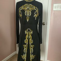 Black Dress Embroidered With Silver And Gold. Mesh Sleeves Knee Length. Size 6 Long Sleeve Embroidered Dresses For Night Out, Black Long Dress With Intricate Embroidery, Long Black Dress With Intricate Embroidery, Festive Black Embellished Embroidered Dress, Fitted Long Sleeve Dress With Gold Embroidery, Elegant Fitted Dress With Gold Embroidery, Black Embellished Long Sleeve Embroidered Dress, Black Long Sleeve Embellished Embroidered Dress, Black Fitted Long Sleeve Embroidered Dress