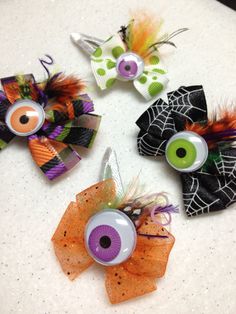 three halloween hair clips with eyes and spider webs