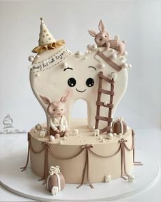 a cake that is shaped like a tooth and has an animal on top of it