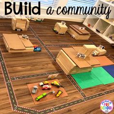 a child's playroom with cardboard boxes and toys on the floor that are laid out