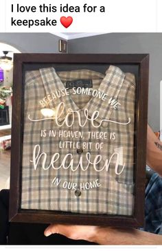 a man holding up a framed sign that says because someone's love is in heaven, there is little bit of heaven in our home