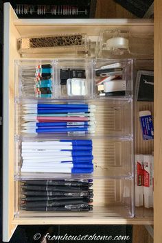 an organized drawer filled with pens and other items