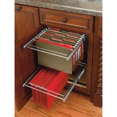 the drawers are full of files and folders in this kitchen cabinet door pullout