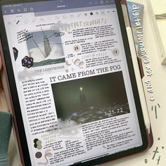 a person holding up an ipad with a page on the screen that reads it came from the fog