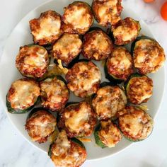 several stuffed zucchini shells on a white plate