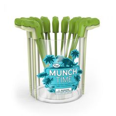 a bunch of green toothbrushes in a glass cup with the words munch time on it