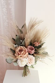 a bouquet of flowers sitting on top of a white table