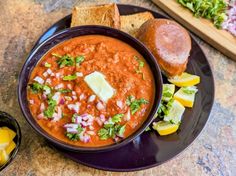 a bowl of soup and some bread on a table