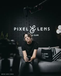 a woman sitting on top of a couch next to a camera