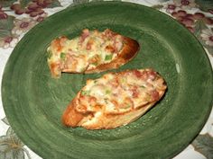 two pieces of pizza on a green plate