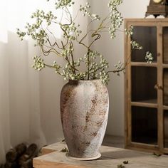 a vase filled with white flowers on top of a table