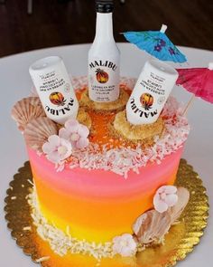 there is a cake that has two bottles on it and some decorations around the top