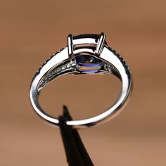 It is a lab created sapphire ring. The main stone is 8mm*8mm cushion cut. weight about 2.75 carats.It's stunning and lovely! The basic metal is sterling silver and plated with rhodium. To change the metal to a solid gold (white/rose) or platinum is also available, please ask for a quotation if you want. You can also go to my shop Home for more elegant rings: https://www.etsy.com/shop/godjewelry?ref=hdr_shop_menu Customization is always welcome and please feel free to contact with me if you have Cushion Cut Sapphire Ring With Cubic Zirconia Accent Stones, Cushion Cut Sapphire Ring With Cubic Zirconia, Cubic Zirconia Sapphire Cushion Cut Ring, Cushion Cut Cubic Zirconia Sapphire Ring, Cushion Cut Lab-created Sapphire Ring In Fine Jewelry Style, Formal Silver Sapphire Ring With Cushion Cut, Elegant Lab-created Sapphire Promise Ring, Cushion Cut Lab-created Sapphire Ring, Sapphire Princess Cut Jewelry With Cubic Zirconia