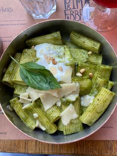 a bowl filled with pasta and cheese on top of a table