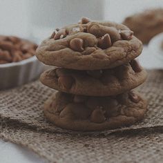 a stack of cookies sitting on top of a table next to a cup of coffee