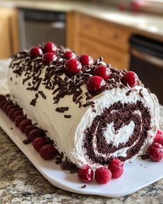 a cake with white frosting and chocolate sprinkles on it sitting on top of a counter