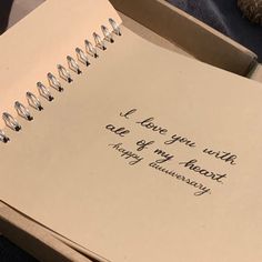 an open notebook with the words i love you with care of my heart and anniversary written on it