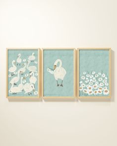 three framed art pieces depicting swans and daisies