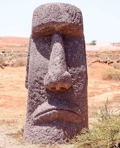 a large stone statue in the middle of nowhere