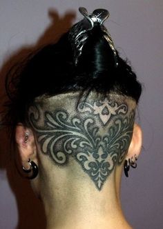 the back of a woman's head with tattoos on it