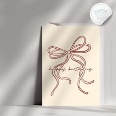 a card with a bow on it and the words happy birthday written in cursive writing